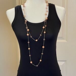 Long, pink bead and faux crystal necklace on silver chain.